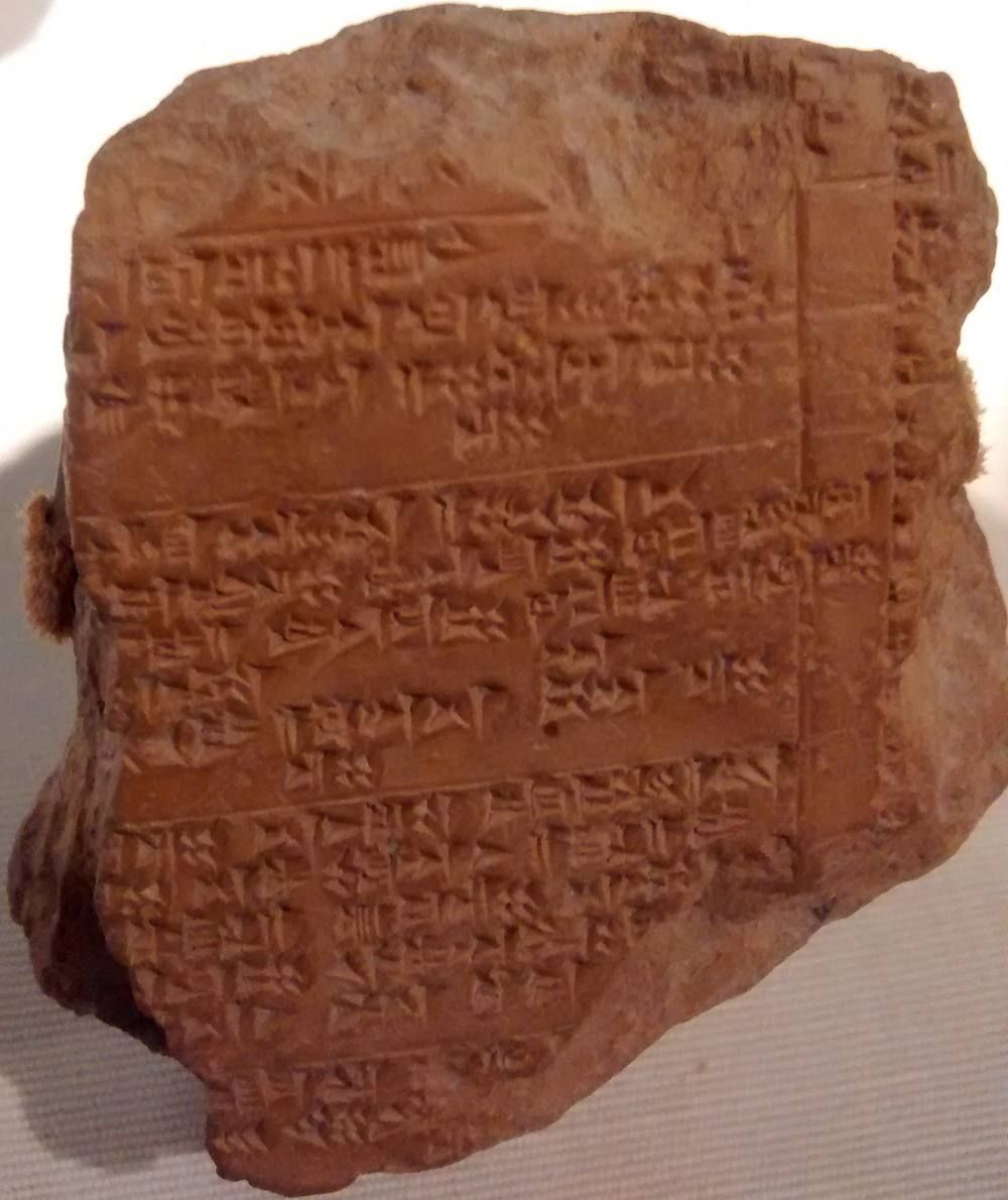 A small rectangular clay tablet covered in rows of wedge-shaped signs.
